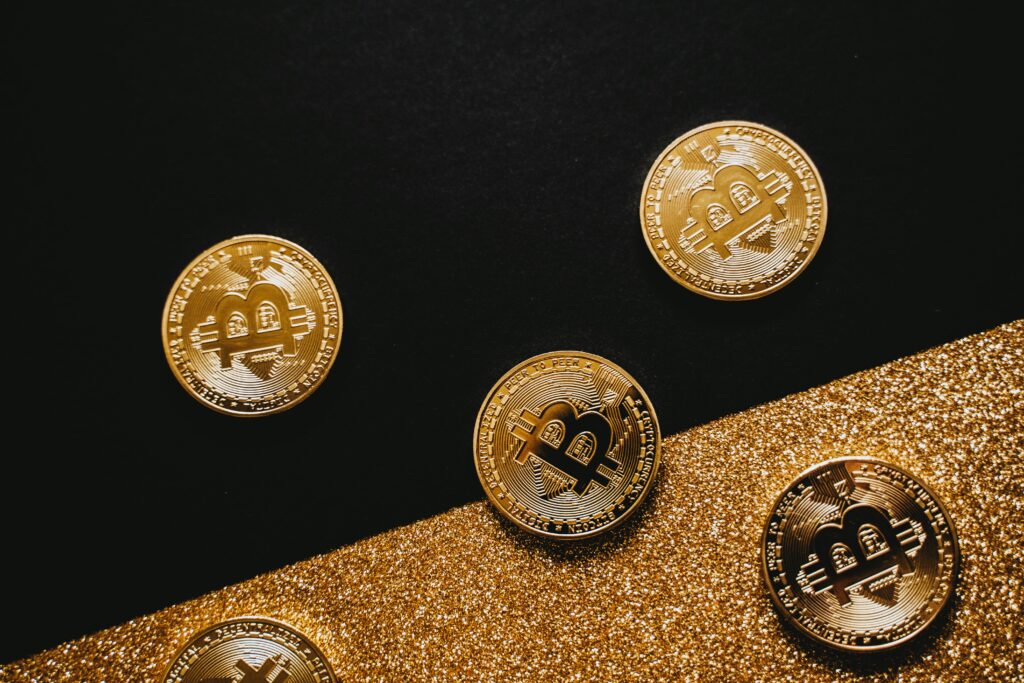 Physical bitcoin coins on black and gold background representing digital wealth an AI crypto trading