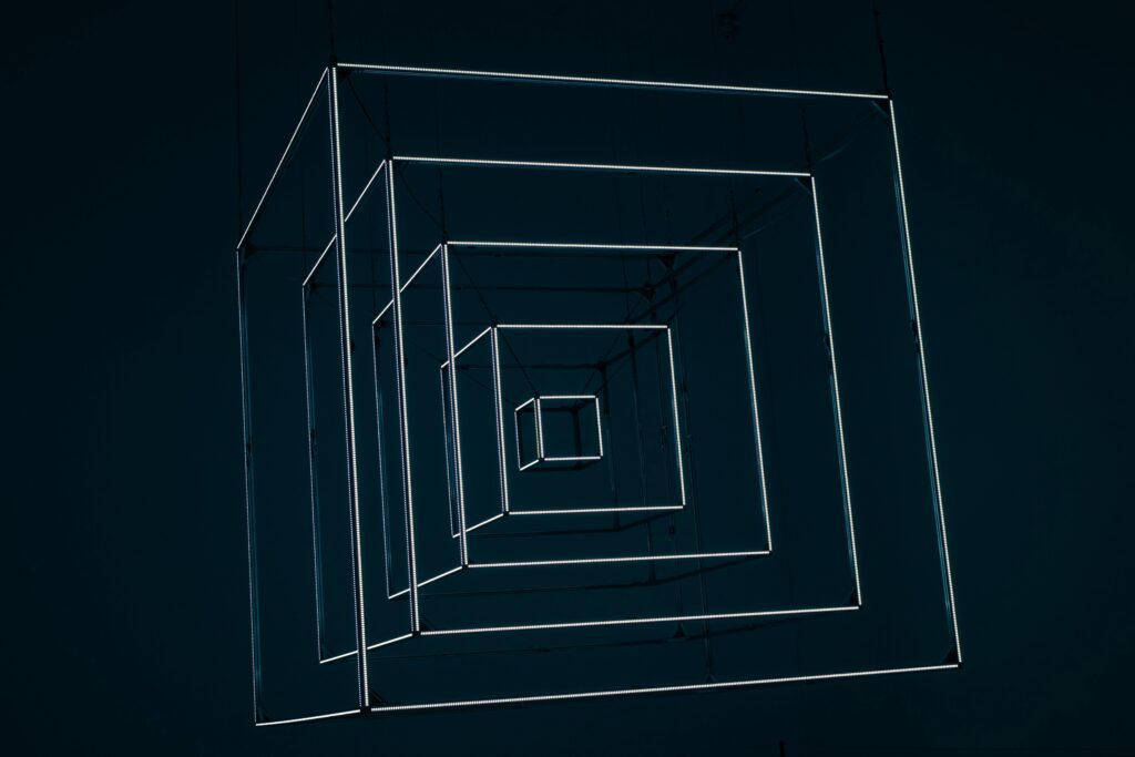Minimalist glowing geometric cube matrix representing abstract layers of autonomous agentic banking network software.